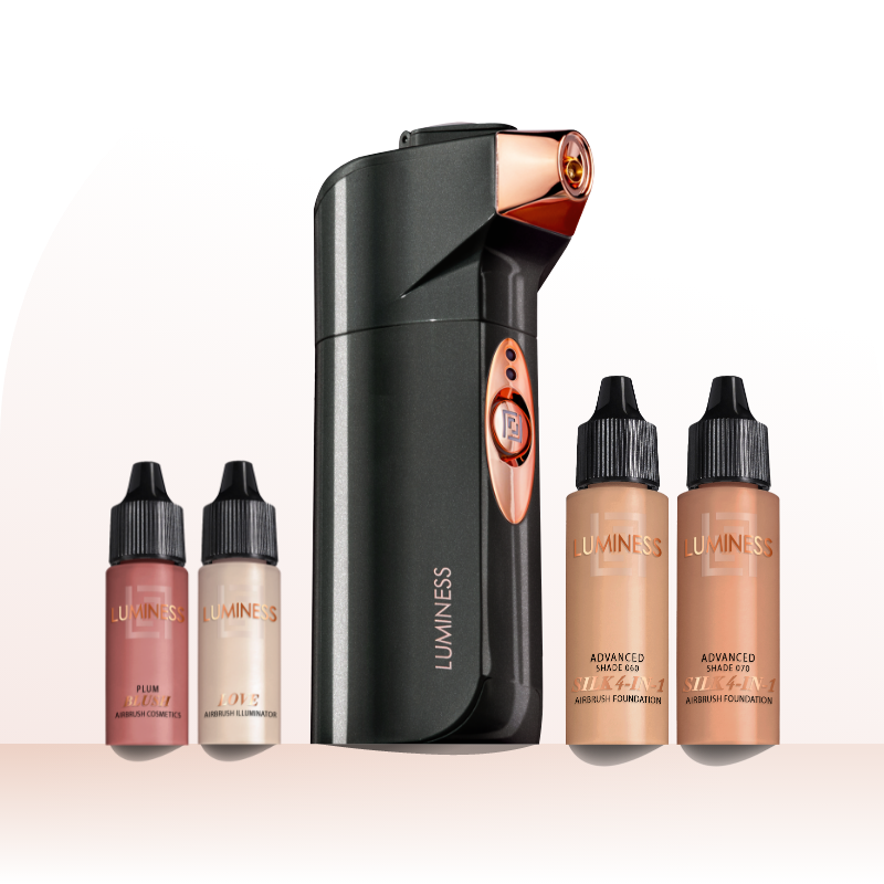 Product lifestyle photo of handheld airbrush spray device with four bottles of foundation
