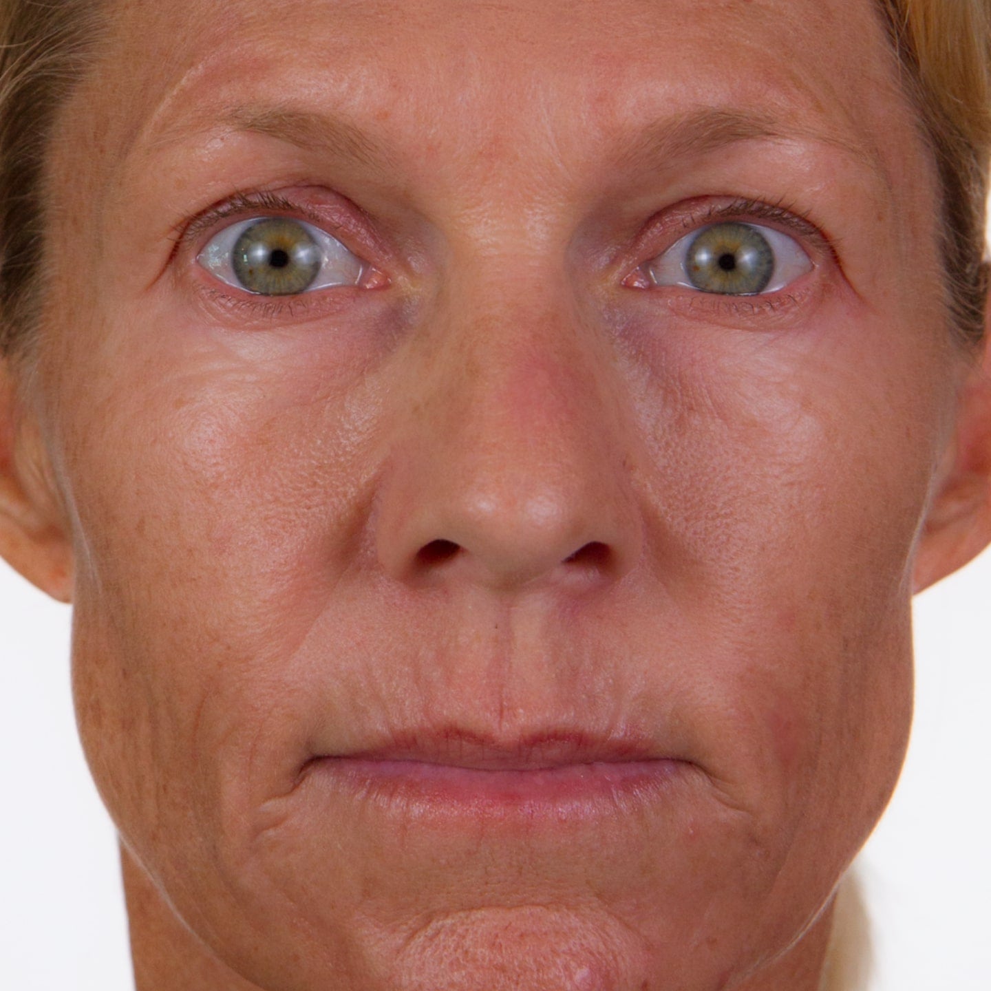 Close up photo of a woman's face with a blank expression