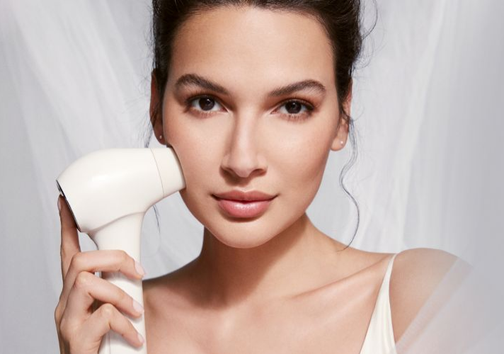 Close up of woman holding skincare device to her cheek