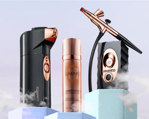 Product lifestyle photo of two different airbrush makeup devices and a bottle of foundation